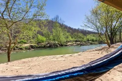 a hammock on a beach next to a river at River Front Hallowed Horse Glamp Tent 2 in Stanton