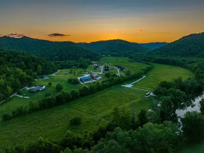 an aerial view of a park with a river and trees at River Front Hallowed Horse Glamp Tent 2 in Stanton
