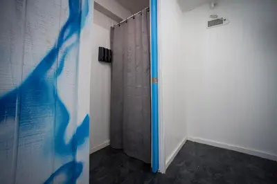 a room with a shower curtain and a door at River Front Hallowed Horse Glamp Tent 2 in Stanton