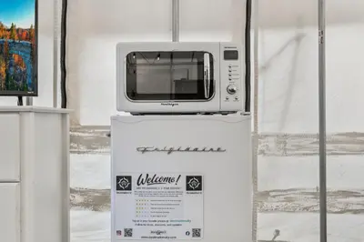 a microwave sitting on top of a box at River Front Hallowed Horse Glamp Tent 2 in Stanton