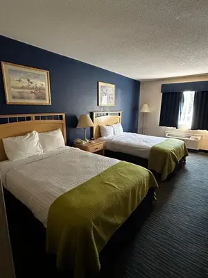 a hotel room with two beds and a window at Ameristay Inn & Suites in Waverly