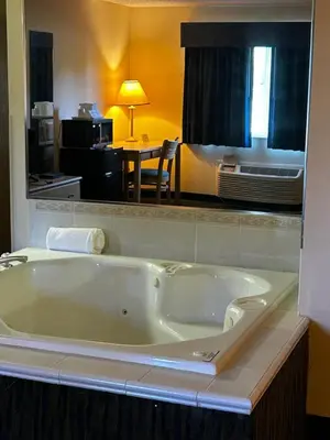a large bath tub in a hotel room at Ameristay Inn & Suites in Waverly
