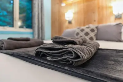 a pile of towels sitting on top of a table at Log Cabin - Natures Oasis - Fire Pit & Gazebo in Cleveland