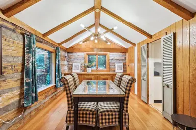 a dining room with a table and two chairs at Log Cabin - Natures Oasis - Fire Pit & Gazebo in Cleveland