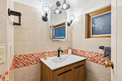 a bathroom with a sink and a mirror at Log Cabin - Natures Oasis - Fire Pit & Gazebo in Cleveland