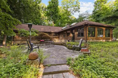 a log cabin with chairs and a patio at Log Cabin - Natures Oasis - Fire Pit & Gazebo in Cleveland