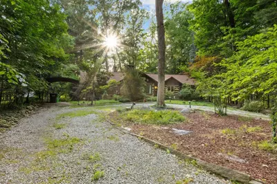 a gravel driveway in front of a house at Log Cabin - Natures Oasis - Fire Pit & Gazebo in Cleveland