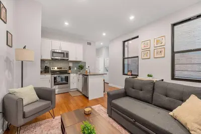 a living room with a couch and a chair and a kitchen at Prime OTR off Vine St, Lux Full Bed, Fast WiFi, Fully Equipped, 50in TV, Sleeps 4ppl in Cincinnati