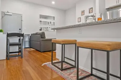 a kitchen and living room with a couch and a bar at Prime OTR off Vine St, Lux Full Bed, Fast WiFi, Fully Equipped, 50in TV, Sleeps 4ppl in Cincinnati