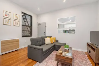 a living room with a couch and a tv at Prime OTR off Vine St, Lux Full Bed, Fast WiFi, Fully Equipped, 50in TV, Sleeps 4ppl in Cincinnati