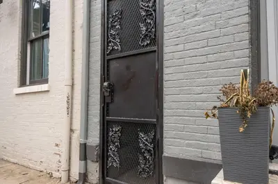 a black door on the side of a building at Prime OTR off Vine St, Lux Full Bed, Fast WiFi, Fully Equipped, 50in TV, Sleeps 4ppl in Cincinnati