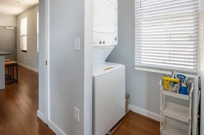 a white refrigerator in a kitchen with a window at OTR, QUEEN Bed, 50in TV, Workspace, Near Lightrail in Cincinnati