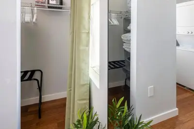 a closet with a glass door and a plant at OTR, QUEEN Bed, 50in TV, Workspace, Near Lightrail in Cincinnati
