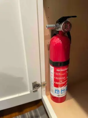 a red fire extinguisher is sitting on a door at OTR, QUEEN Bed, 50in TV, Workspace, Near Lightrail in Cincinnati