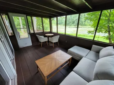 a living room with a couch and a table at Turkey Trot, Cabin Getaway on Lake w/ Hot Tub in Streetsboro