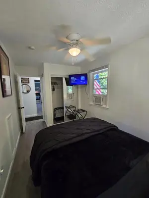 a bedroom with a bed and a ceiling fan at Turkey Trot, Cabin Getaway on Lake w/ Hot Tub in Streetsboro