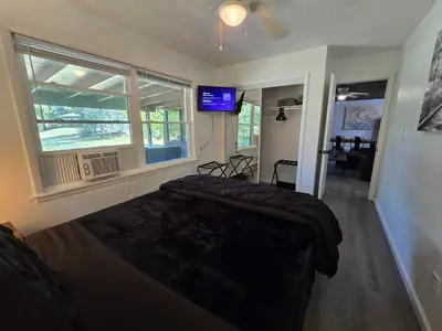 a bedroom with a bed and a television in it at Turkey Trot, Cabin Getaway on Lake w/ Hot Tub in Streetsboro