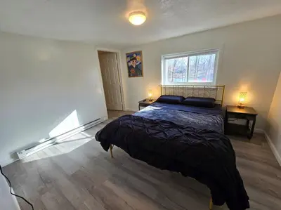 a bedroom with a bed and a window at Eagles Nest At Heron Hill Retreat Hot Tub on Lake! in Streetsboro