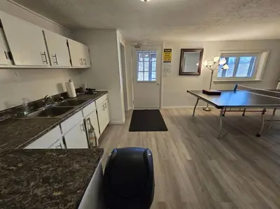 a kitchen with a desk and a table in it at Eagles Nest At Heron Hill Retreat Hot Tub on Lake! in Streetsboro