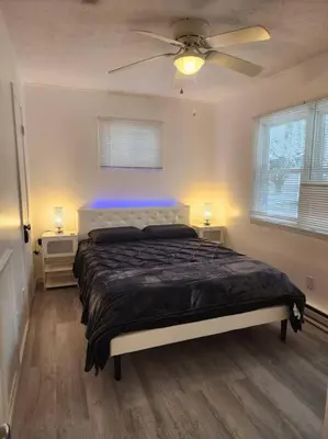 a bedroom with a bed and a ceiling fan at Eagles Nest At Heron Hill Retreat Hot Tub on Lake! in Streetsboro