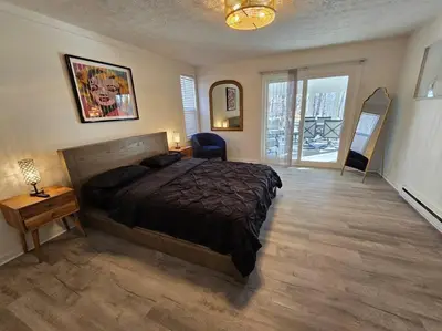 a bedroom with a bed and a desk and a window at White Tail Run At Heron Hill Retreat Hot Tub Lake! in Streetsboro