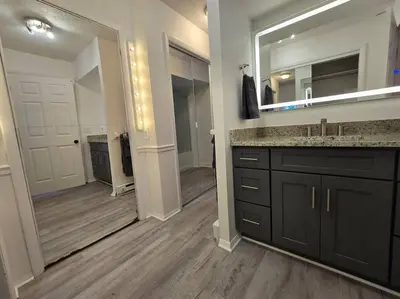 a bathroom with a sink and a large mirror at White Tail Run At Heron Hill Retreat Hot Tub Lake! in Streetsboro