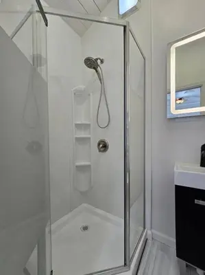 a shower with a glass door in a bathroom at White Tail Run At Heron Hill Retreat Hot Tub Lake! in Streetsboro