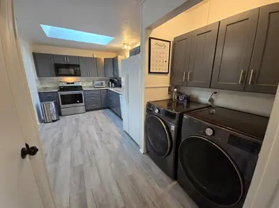 a kitchen with a washer and dryer in a room at White Tail Run At Heron Hill Retreat Hot Tub Lake! in Streetsboro