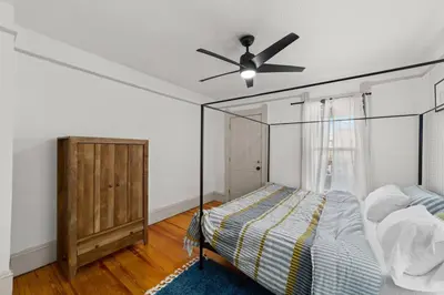 a bedroom with a bed and a ceiling fan at Pet Friendly 2BR in Little Italy # 3 in Cleveland