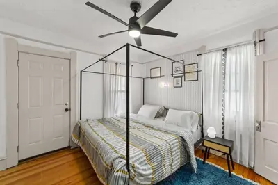 a bedroom with a bed with a ceiling fan at Pet Friendly 2BR in Little Italy # 3 in Cleveland