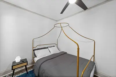 a bedroom with a bed with a metal canopy at Pet Friendly 2BR in Little Italy # 3 in Cleveland