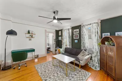 a living room with a couch and a ceiling fan at Pet Friendly 2BR in Little Italy # 3 in Cleveland