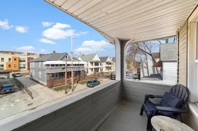 a balcony with two chairs and a view of a street at Pet Friendly 2BR in Little Italy # 3 in Cleveland