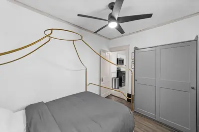 a bedroom with a bed and a ceiling fan at Pet Friendly 2BR in Little Italy # 3 in Cleveland