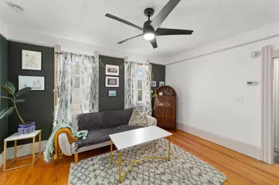 a living room with a couch and a ceiling fan at Pet Friendly 2BR in Little Italy # 3 in Cleveland