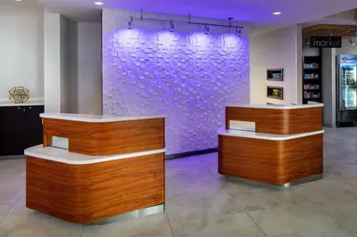 a store with two counters and a purple wall at Courtyard by Marriott Charleston Downtown/Civic Center in Charleston