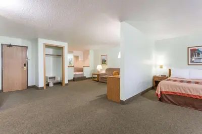 a large hotel room with a bed and a bed sidx sidx sidx sidx at Super 8 by Wyndham Gallipolis Pt Pleasant Area in Gallipolis