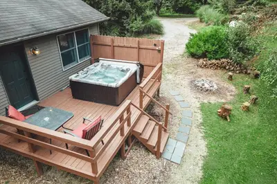 a deck with a hot tub on top of a house at King Bed House w Private Hot Tub in South Bloomingville