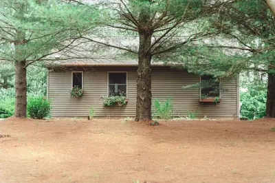a house with two trees in front of it at King Bed House w Private Hot Tub in South Bloomingville