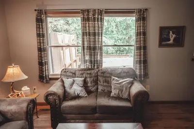 a living room with a couch and a window at King Bed House w Private Hot Tub in South Bloomingville