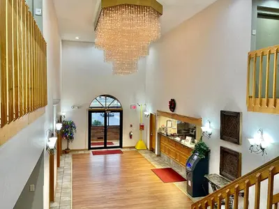 a hallway with a large chandelier in a building at FairBridge Inn & Suites Fort Wayne in Fort Wayne