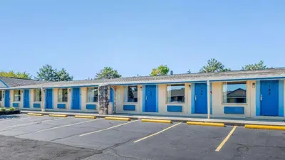 a building with blue doors in a parking lot at Hilliard Motor Lodge in Hilliard