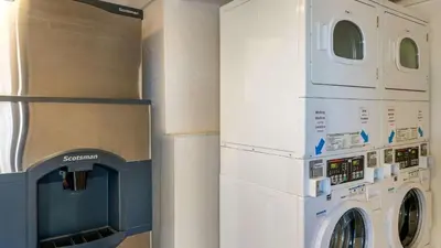 two washer and dryers are next to a wall at Hilliard Motor Lodge in Hilliard