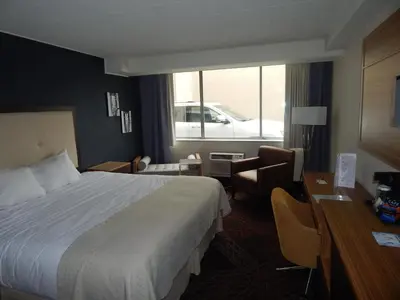a hotel room with a bed and a desk at Ramada by Wyndham Beaver Falls in Beaver Falls