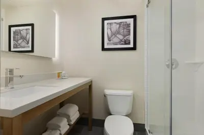 a bathroom with a toilet and a sink and a shower at Ramada by Wyndham Beaver Falls in Beaver Falls