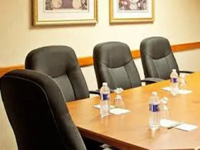 a group of chairs around a table with water bottles at Ramada by Wyndham Beaver Falls in Beaver Falls