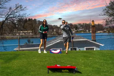 two people standing in a field with a kite at Hilltop Lakehouse - Free Kayaks Deck PLX in Akron