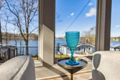 a blue glass sitting on a table in front of a window at Hilltop Lakehouse - Free Kayaks Deck PLX in Akron