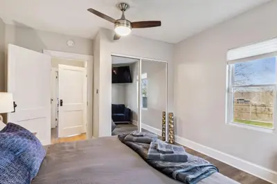 a bedroom with a bed and a ceiling fan at Hilltop Lakehouse - Free Kayaks Deck PLX in Akron