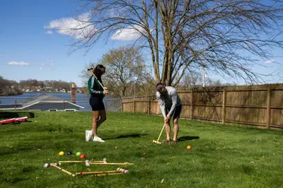 two people playing a game of dominoes in a yard at Hilltop Lakehouse - Free Kayaks Deck PLX in Akron